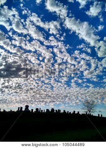 Cemetery Tombstone Skyline Silhouette Against Dramatic Clouds