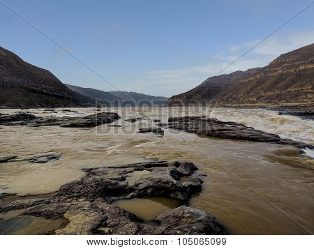 the broad and peaceful river channel of the Yellow river with eroded rocks