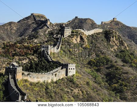 the Great Wall and mountains with colorful leafs and clear blue sky in fall