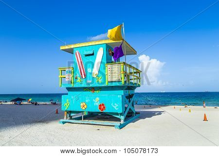People Enjoy The Beach Next To A Lifeguard Tower