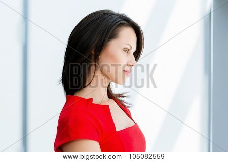 Modern business woman standing in front of window