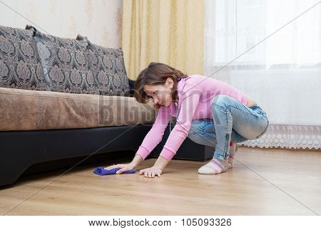 Young Woman Washing Wooden Floor With Blue Floorcloth