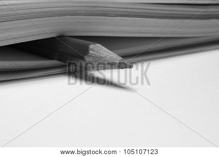 Close note book and pencil inside