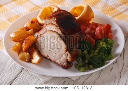 Sunday Roast: Pork With Vegetables And Yorkshire Pudding Closeup.
