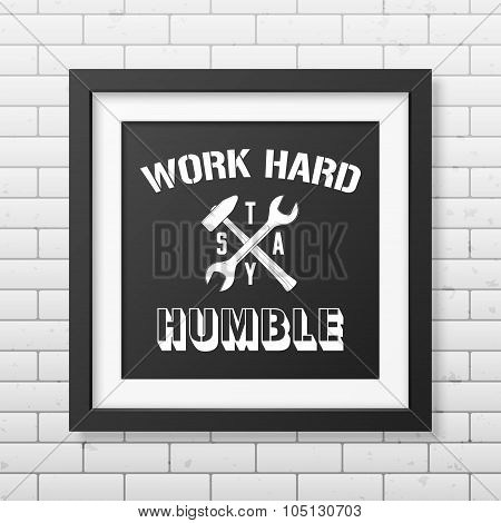 Quote typographical Background in realistic square black frame on the brick wall background