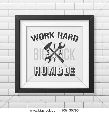 Quote typographical Background in realistic square black frame on the brick wall background