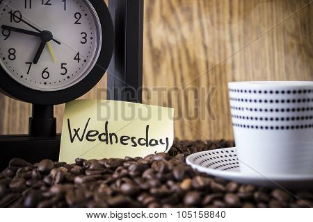 Cup Polka Dots, Clock And A Sticker With The Day Standing On Coffee Beans. Blur, Focus On Sticker