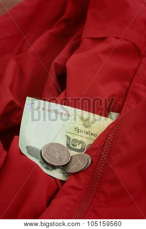 Thailand Baht Banknotes With Thailand Baht Coins On Red Shirt.