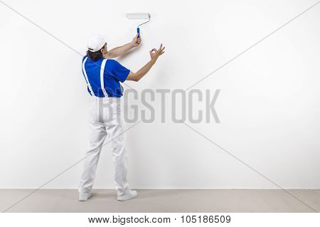 Painter With Paintroller Doing Ok On White Wall