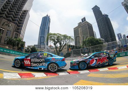 KUALA LUMPUR, MALAYSIA - AUGUST 09, 2015: Scott McLaughlin leads Chaz Mostert as they race in the streets of Kuala Lumpur in the V8 Supercars Street Challenge at the 2015 Kuala Lumpur City Grand Prix.