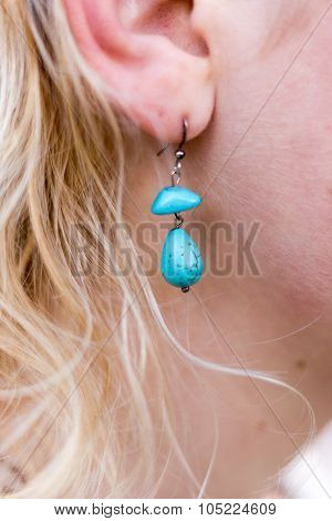 Girl with blue earrings