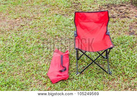 Foldable Camping Chair With The Green Lawn Background.
