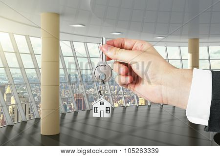 Hand With Key From A New Big Office