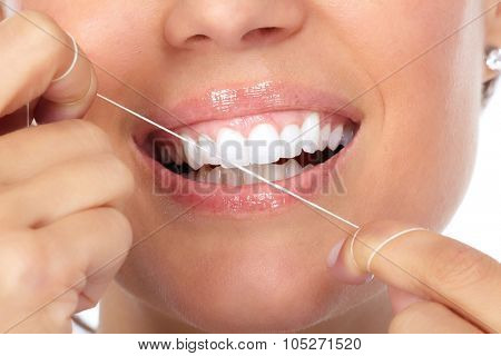 Woman teeth with dental floss. Dentistry health care.