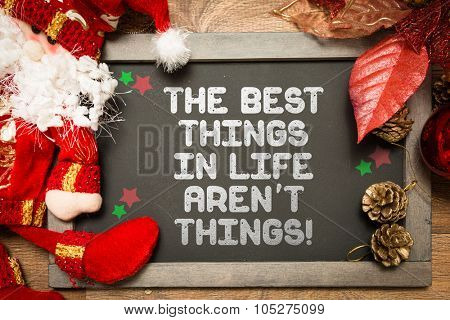 Blackboard with the text: The Best Things In Life Aren't Things in a christmas conceptual image