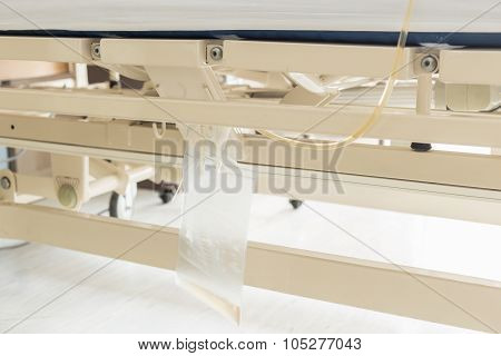 Clear Plastic Urine Bag Hang On Bed Of Female Patient