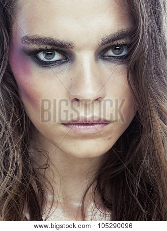 young beauty woman with makeup like shiner on face close up isolated white background