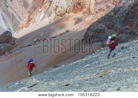 Two men climbing on the top.