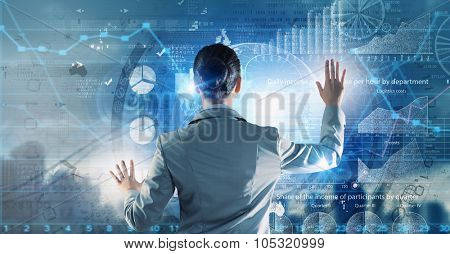 Back view of businesswoman working with digital virtual panel
