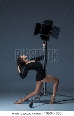The Beautiful Ballerina Posing On Dack Blue Background