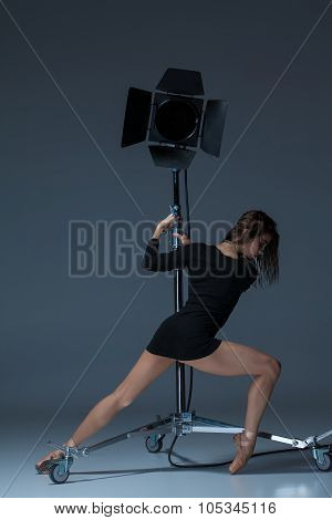The Beautiful Ballerina Posing On Dack Blue Background