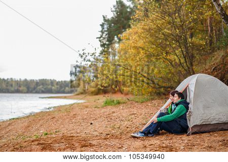 Attractive young couple camping trip in forest