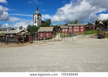 View to the traditional wooden houses and church bell tower of the copper mines town of Roros in Ro