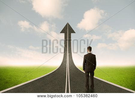 Businessman lokking at 3d road upgoing arrow concept