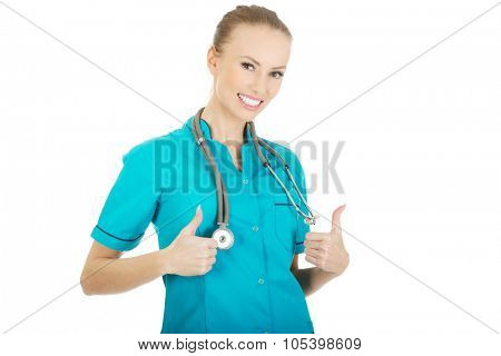Beautiful smiling woman doctor with thumbs up.