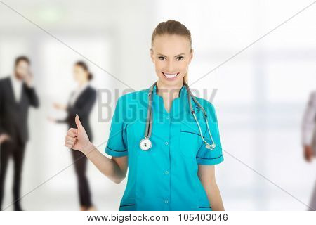Beautiful smiling woman doctor with thumbs up.