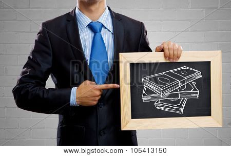 Unrecognizable businessman holding blackboard with drawn money concept