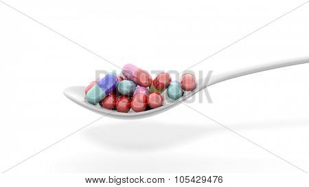 Colorful caplets inside a spoon, isolated on white background.