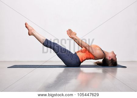 Beautiful sporty fit yogini woman practices yoga asana Uttana padasana - raised legs pose