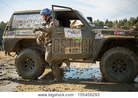 RUSSIA, PUSHKINO -?? 20 SEP, 2014: Driver is going out from off-road vehicle at Rainforest Challenge Russia Autumn 2014 PRO-X.