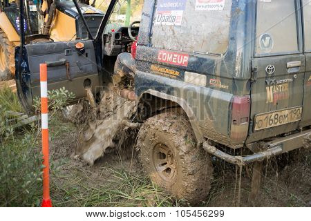 RUSSIA, PUSHKINO -?? 20 SEP, 2014: Dirty water is going out from the cars cabin at Rainforest Challenge Russia Autumn 2014 PRO-X.