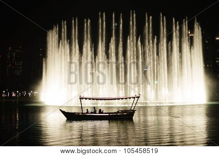 DUBAI, UAE - OCTOBER 15, 2014: The Dubai Fountain at night. The Dubai Fountain is the world's largest choreographed fountain system set on the 30-acre manmade Burj Khalifa Lake.