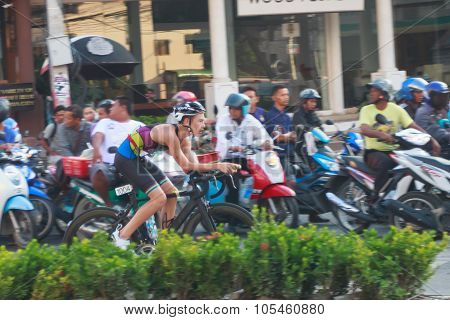 PATTAYA - OCT 17 2015: Side view of unidentified triathlete cycling in the Pataya Triathlon 2015 event October 17 2015 in Pattaya Thailand.