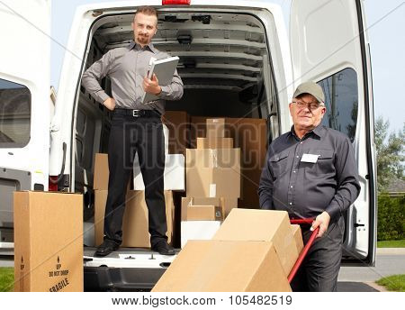 Group of delivery men with parcels near shipping truck. Parcel service.