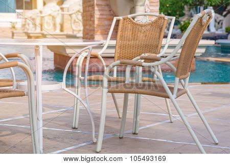 Chairs And Tables Next To Swimming Pool