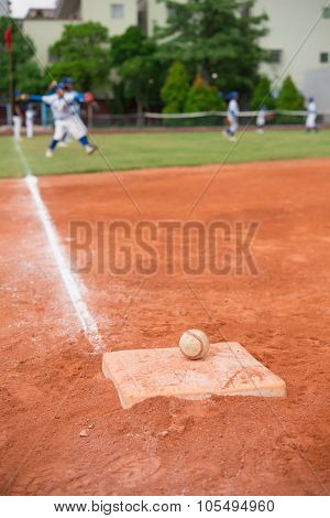 Baseball And Base On Baseball Field With Players On Background