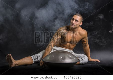 Male Drummer Drumming on Steel Drums in Studio