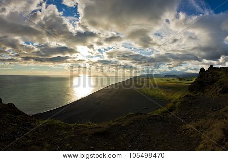 Sunset on a black beach, a view from Dyrholaey rock, Iceland