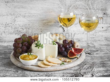 Delicious Appetizer To Wine - Ham, Cheese, Grapes, Crackers, Figs, Nuts, Jam, Served On A Light Wood