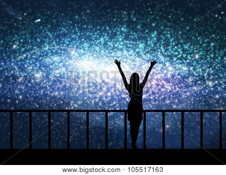 Silhouette of young woman in the cosmos