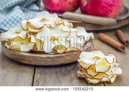 Healthy Snack. Homemade Dehydrated Apple Chips On Rustic Wooden Background