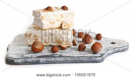 Sweet nougat with hazelnuts isolated on white