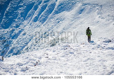 Brave traveler, snowboarder freerider in the mountains experiencing new tracks