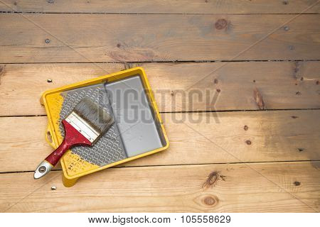Wooden Plank Floor Varnishing. Gray Varnish And Paintbrush In Tray