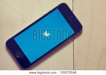 Iphone With Twitter App On Wooden Background