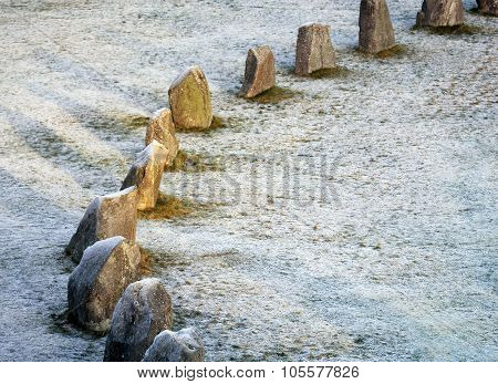 The Big Stones Standing In The Snow Field In Winter